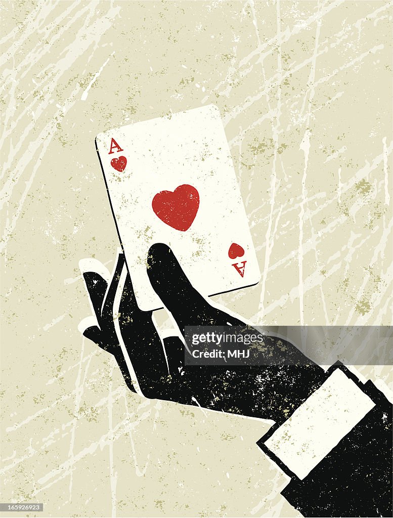 Man's Hand Holding an Ace of Hearts Playing Card