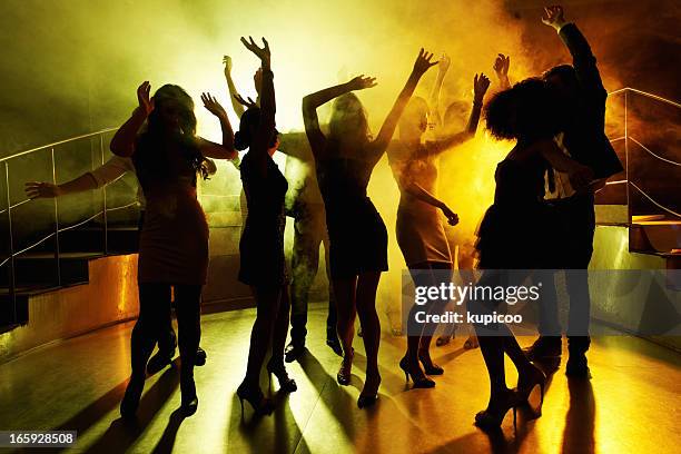 people grooving on the dance floor at a night club - dance floor stock pictures, royalty-free photos & images