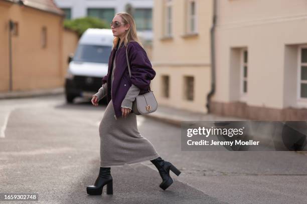 Sonia Lyson seen wearing Miu Miu brown transparent sunglasses, Fendi beige knit pullover, matching beige knit long skirt, The Frankie Shop purple...