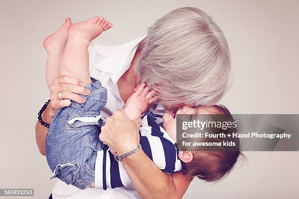 grandma hugging child - baby studio shot stock pictures, royalty-free photos & images