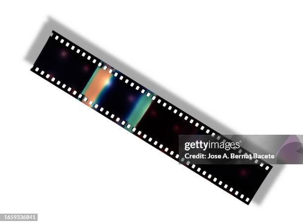 color negative 35mm film stripes on a white background with a small shadow. - photographic slide stock pictures, royalty-free photos & images
