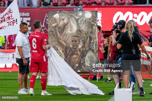 Wout Brama of FC Twente 2010 & 2011 uncovering a painting during the Farewell match of Wout Brama between FC Twente 2010 & 2011 and Wouts All Stars...