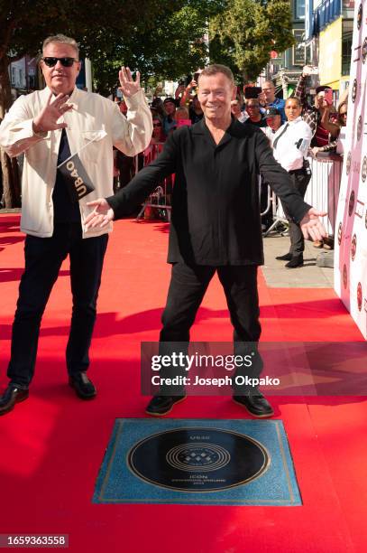 Graham McPherson aka Suggs of Madness poses with Ali Campbell of UB40 next to UB40's Music Walk of Fame plaque at the unveiling of The Music Walk Of...