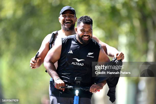 Ofa Tu'ungafasi and Samisoni Taukeiaho of the All Blacks ride on a scooter following a New Zealand All Blacks training session at LOU rugby club on...