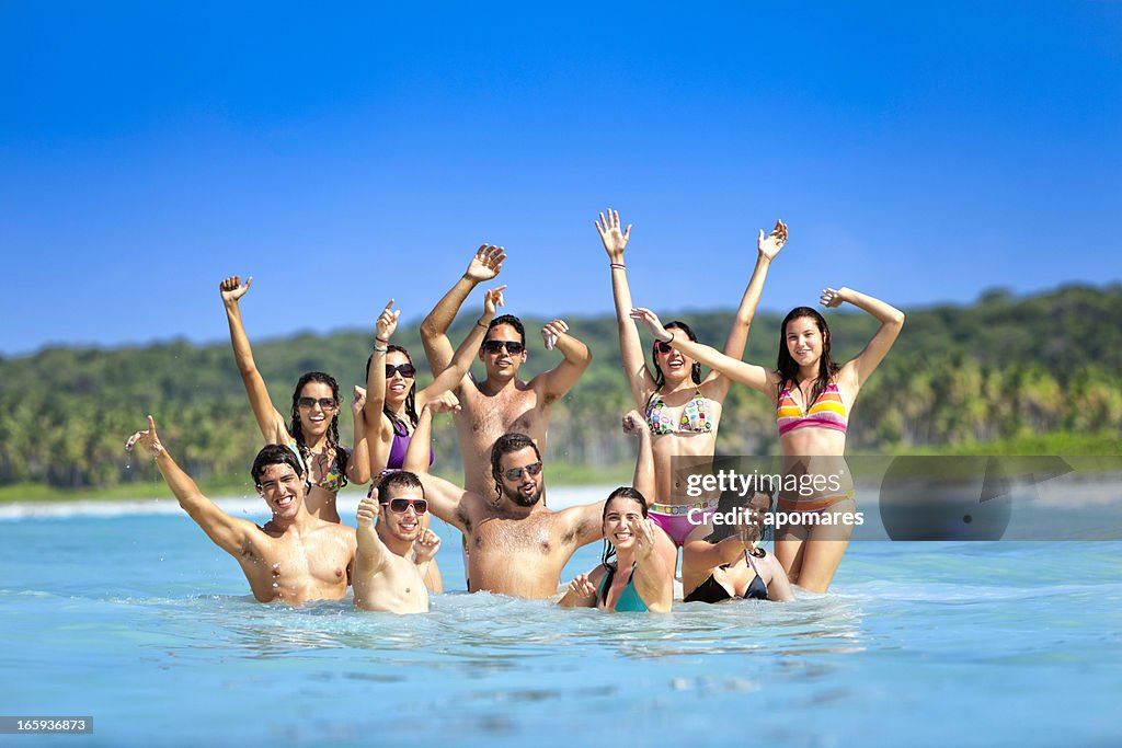 Group of young people having fun in a tropical beach