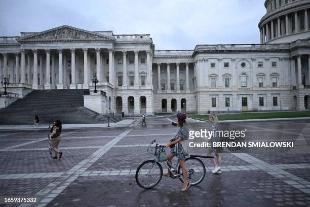 People stop to observe a minute of silence outside the US Capitol to honor the people killed in the September 11, 2001 terrorist attack in...
