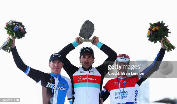 Race winner Fabian Cancellara of Switzerland and Radioshack Leopard celebrates on the podium with second placed Sep Vanmarcke of Belgium and Blanco...
