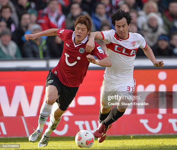 Hiroki Sakaii of Hannover is challenged by Shinji Okazaki of Stuttgart during the Bundesliga match between Hannover 96 v VfB Stuttgart at AWD Arena...