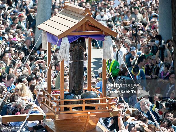 Large phallic-shaped 'Mikoshi' float through the streets during Kanamara Matsuri on April 7, 2013 in Kawasaki, Japan. The festival is held annually...