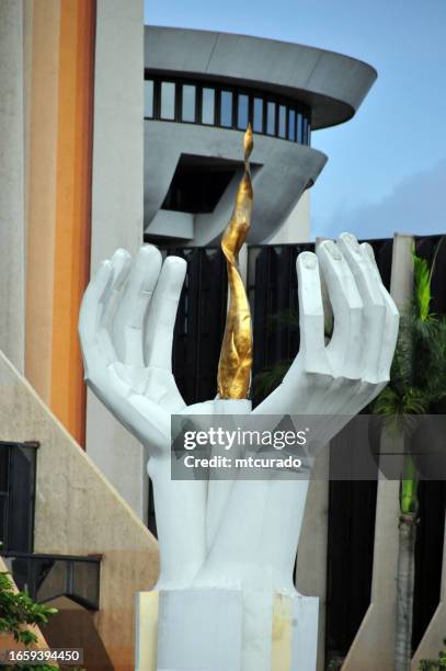 gabonese oil and gas ministry - golden flame in front of the building, libreville, gabon - libreville stock pictures, royalty-free photos & images