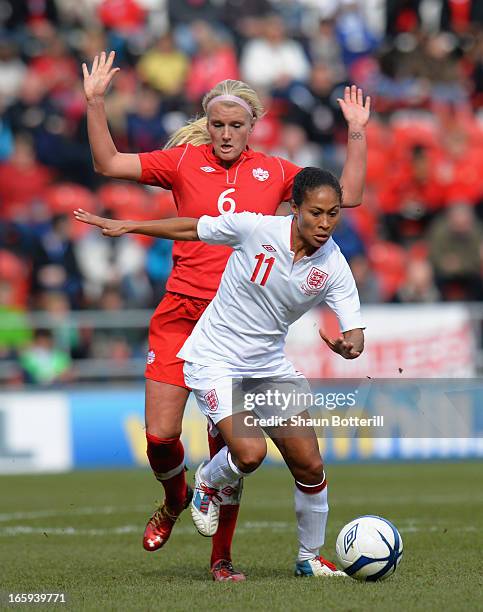 Rachel Yankey of England breaks away from Kaylyn Kyle of Canada during the Women's International Match between England Women and Canada Women at The...