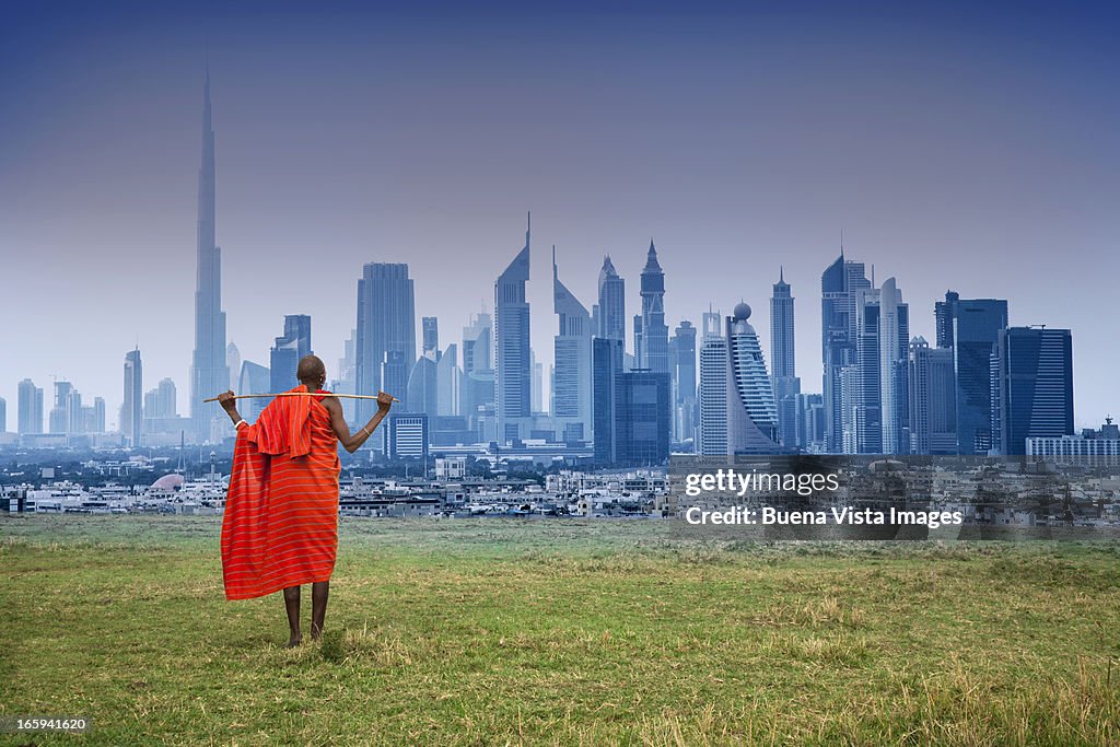 Masai shepherd watching futuristic city