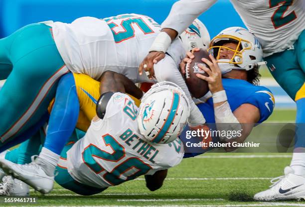 Inglewood, CA, Sunday, Sept. 10, 2023 - Los Angeles Chargers quarterback Justin Herbert is sacked by Miami Dolphins linebacker Jaelan Phillips and...