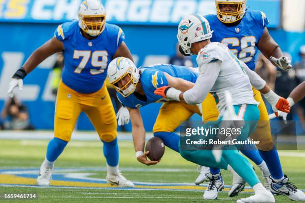 Inglewood, CA, Sunday, Sept. 10, 2023 - Los Angeles Chargers quarterback Justin Herbert stumbles out of the pocket to scramble for a few yards on a...