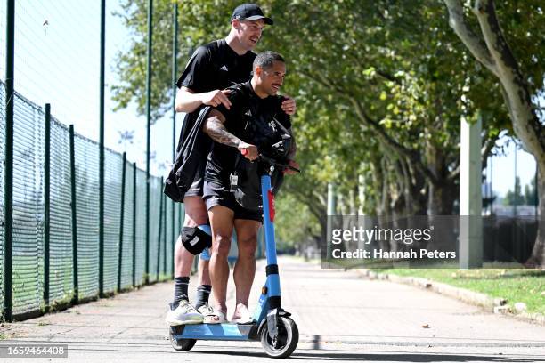 Brodie Retallick and Aaron Smith of the All Blacks ride on a scooter following a New Zealand All Blacks training session at LOU rugby club on...