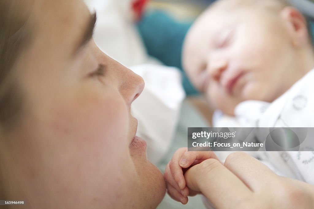 Woman holding her 2 days old daughter
