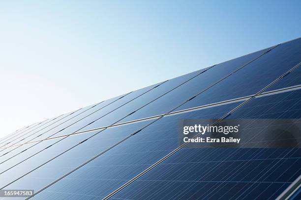 solar panels against blue sky. - pannello solare foto e immagini stock