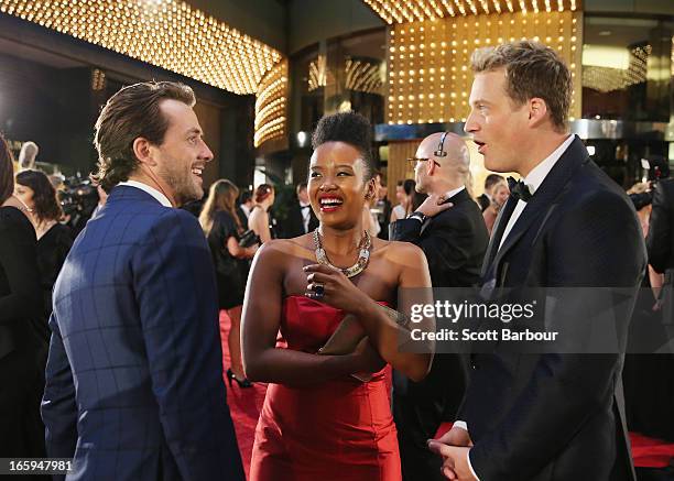 Darren McMullen, Faustina Agolley and Jules Lund talk as they arrive at the 2013 Logie Awards at the Crown on April 7, 2013 in Melbourne, Australia.