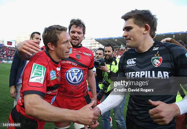 Jonny Wilkinson who kicked all of Toulon's points commiserates with his opposite number Toby Flood of Leicester after their victory after the...