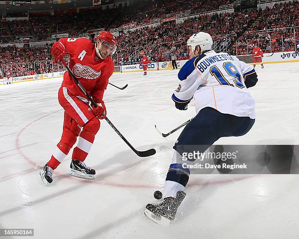 Pavel Datsyuk of the Detroit Red Wings tries to make a move on Jay Bouwmeester of the St. Louis Blues but the puck ends up in his feet during a NHL...