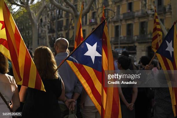 People carrying Catalan pro-independence Estelada flags take part in demonstrations to mark Catalonia's national day 'La Diada' at the Fossar de les...