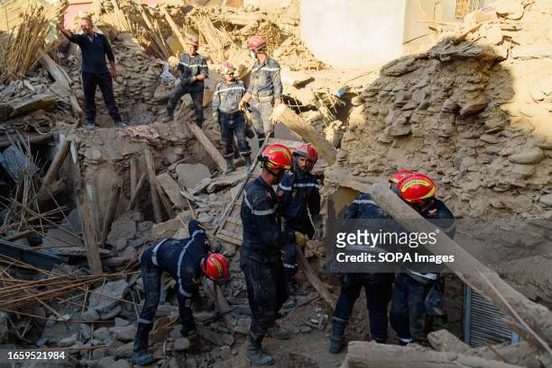 Firefighters are seen digging among the rubble in search of survivors in the aftermath of the earthquake in Amizmiz. In a race against time, search...