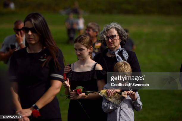 Visitors listen to the roll call of names of the victims during a ceremony commemorating the 22nd anniversary of the crash of Flight 93 during the...