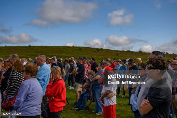 Visitors listen to the roll call of names of the victims during a ceremony commemorating the 22nd anniversary of the crash of Flight 93 during the...