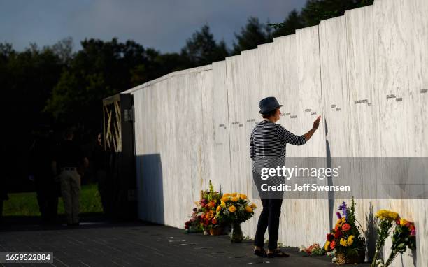 Relative of one of the victims pays her respects at the Wall of Names before a ceremony commemorating the 22nd anniversary of the crash of Flight 93...