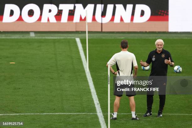 Rudi Voeller , director of the Germany national team, oversees a training session with Interim co-coach Hannes Wolf on the eve of the friendly...