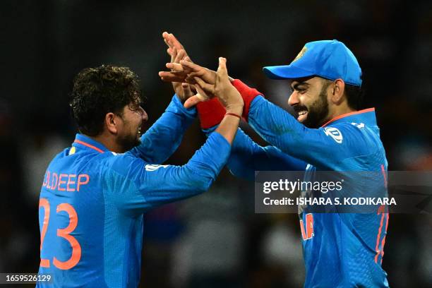 India's Kuldeep Yadav and Virat Kohli celebrate their team's victory at the end of the Asia Cup 2023 super four one-day international cricket match...