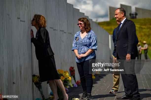 United States Second Gentleman Douglas Emhoff walks along the Wall of Names with Deborah Borza, mother of crash victim Deora Frances Bodley, as she...