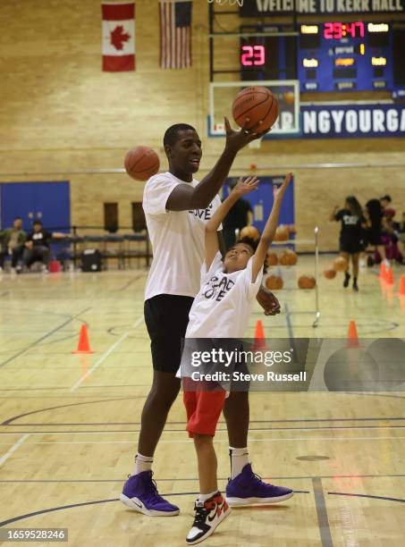 Pro basketball player Andrew Nicholson out rebounds Ashton Ayres, actor: The Manny during warm-ups. 1st Annual Battleground: Uniting for a...