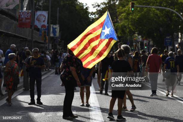 Demonstrators wave Catalan pro-independence 'Estelada' flags as they gather during the 'Diada' celebrations, the national day of Catalonia, on the...