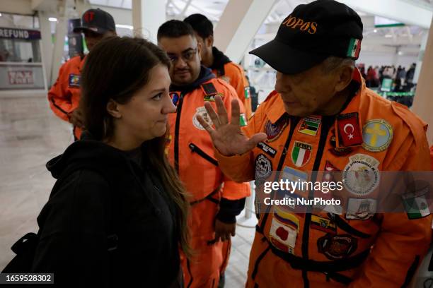 Héctor Méndez, better known as El Chino, head and founder of the Azteca Topos International Rescue Brigade, talks with a Turkish citizen inside the...