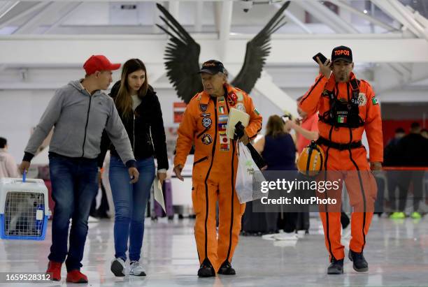 At the centre, Héctor Méndez, better known as El Chino, head and founder of the Azteca Topos International Rescue Brigade, arrives at the Mexico City...