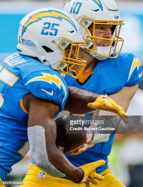 Inglewood, CA, Sunday, Sept. 10, 2023 -Los Angeles Chargers quarterback Justin Herbert hands off to Los Angeles Chargers running back Joshua Kelley...