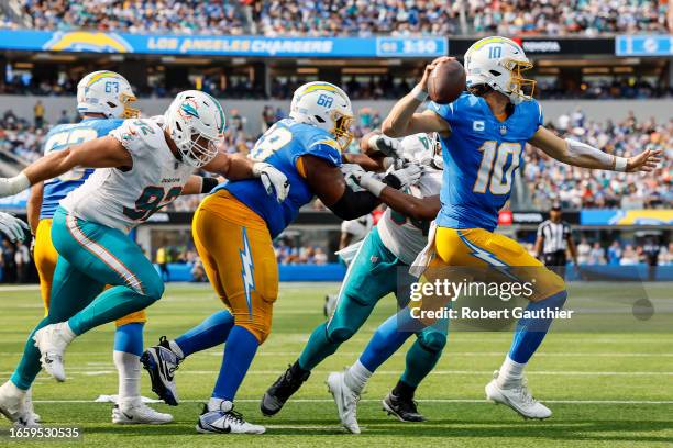 Inglewood, CA, Sunday, Sept. 10, 2023 - Los Angeles Chargers quarterback Justin Herbert scrambles from pressure against the Miami Dolphins at SoFi...