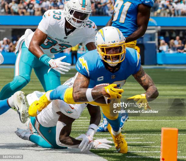 Inglewood, CA, Sunday, Sept. 10, 2023 - Los Angeles Chargers wide receiver Keenan Allen strains to gain yardage on a play against the Miami Dolphins...