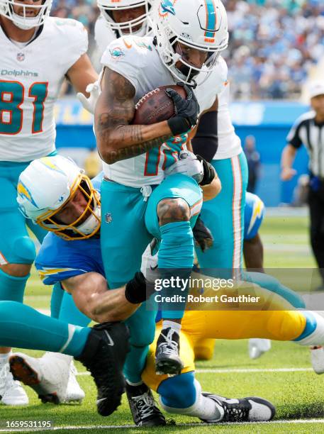 Inglewood, CA, Sunday, Sept. 10, 2023 - Miami Dolphins wide receiver Erik Ezukanma runs through the tackle of Los Angeles Chargers linebacker Joey...