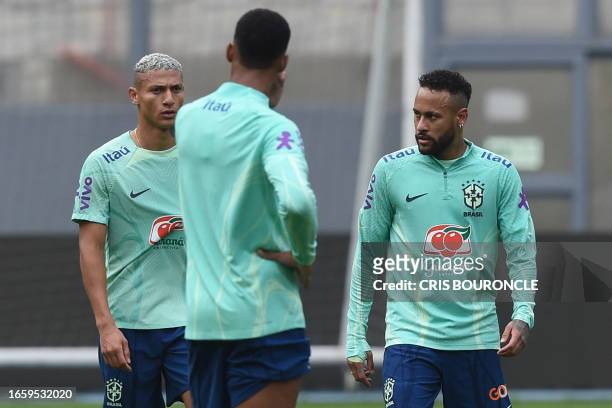 Brazil's forward Neymar looks at Brazil's forward Richarlison during a training session in Lima, on September 11 on the eve of their 2026 FIFA World...