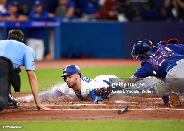 Kevin Kiermaier of the Toronto Blue Jays is tagged out at home plate by Jonah Heim of the Texas Rangers in the fifth inning at Rogers Centre on...