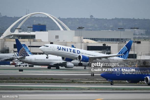 United Airlines Boeing 737 MAX 9 airplane passes a Southwest Airlines Boeing 737 while taking off from Los Angeles International Airport as seen from...