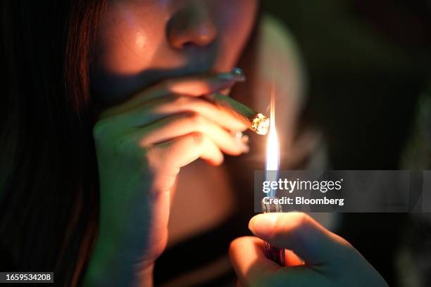 Customer lights up a joint inside a cannabis dispensary in Bangkok, Thailand, on Sunday, Sept. 10, 2023. An ongoing regulatory vacuum, which emerged...