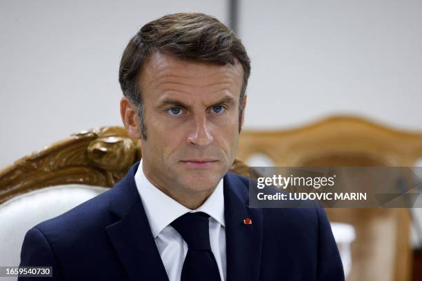 This picture taken on September 11 shows France's President Emmanuel Macron attend the ceremony of signing bilateral agreements with Bangladesh's...