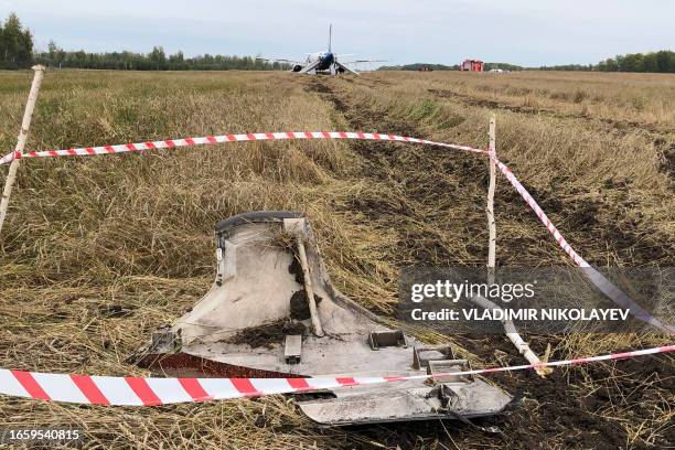 This photo taken on September 12, 2023 shows wreckage of an Ural Airlines Airbus A320 passenger plane following its emergency landing in a field near...