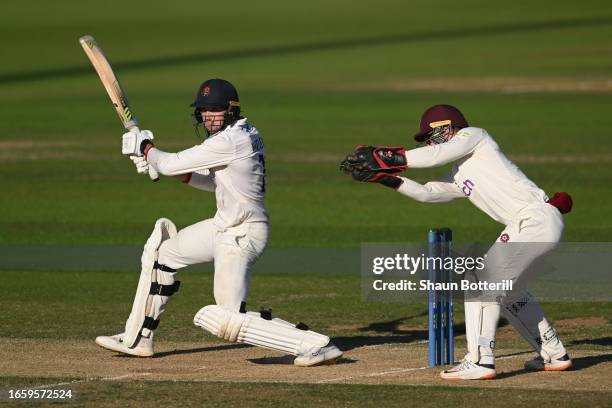 Tom Hartley of Lancashire plays a shot as Northamptonshire wicketkeeper Lewis McManus looks on during day 2 of the LV= Insurance County Championship...