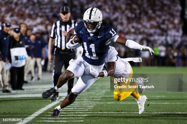 Malik McClain of the Penn State Nittany Lions makes a catch against Montre Miller of the West Virginia Mountaineers during the first half at Beaver...