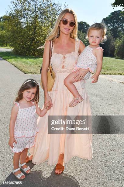 Millie Mackintosh poses with daughters Sienna and Aurelia at an event hosted by Green Tree Badge by Bags of Ethics and Royal Forestry Society at Kew...