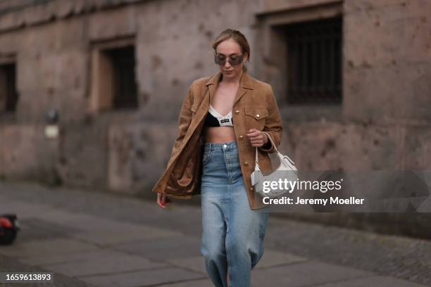 Sonia Lyson seen wearing Miu Miu brown transparent sunglasses, Miu Miu white / black knit bra, Miu Miu brown suede leather jacket, Miu Miu white...